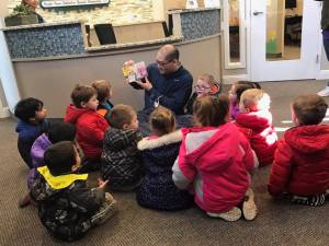Dr. John and Dr. Wong giving preschool children an office tour