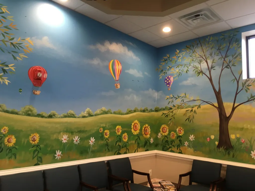 {PRACTICE_NAME} Harleysville office waiting area with colorful scenic murals on the wall