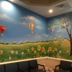 {PRACTICE_NAME} Harleysville office waiting area with colorful scenic murals on the wall