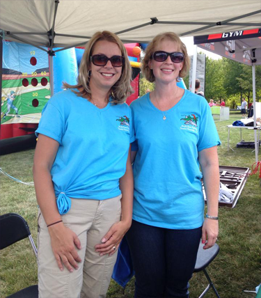 Two staff members posing at Montgomery Township's 300th Anniversary in September 2014