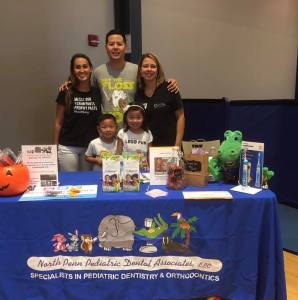 Dr. Wong posing with staff and children at North Penn Under Ten’s Fall Fest