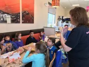 Holly speaking to a Daisy Troop about dental care Saturday morning at Dunkin' Donuts